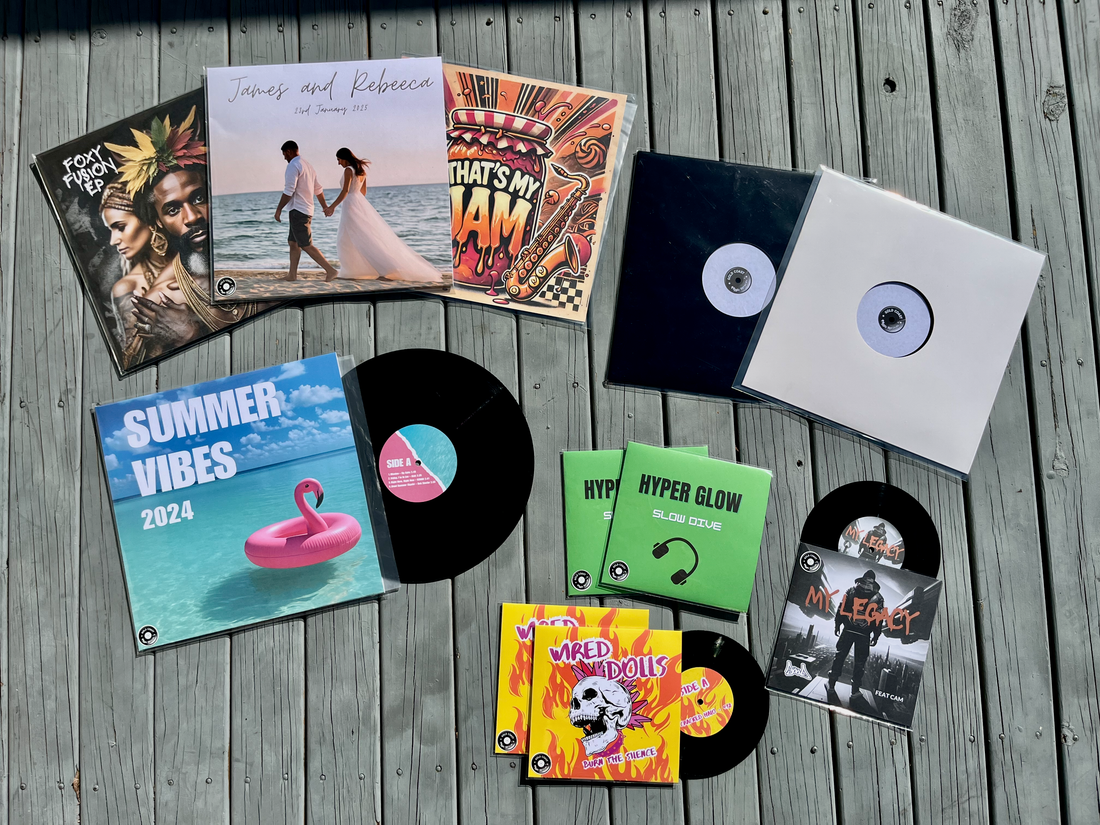 Custom vinyl records in 7", 10" and 12" sizes, in white and full colour jacket designs, laid out on a wooden deck